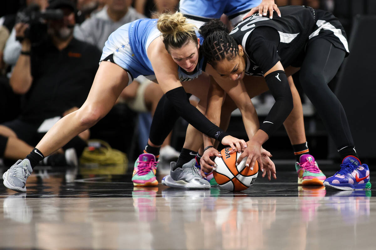 Chicago Sky guard Marina Mabrey, left, and Las Vegas Aces center A'ja Wilson struggle for a loo ...