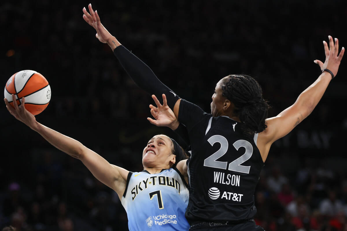 Chicago Sky guard Chennedy Carter (7) shoots while Las Vegas Aces center A'ja Wilson (22) defen ...