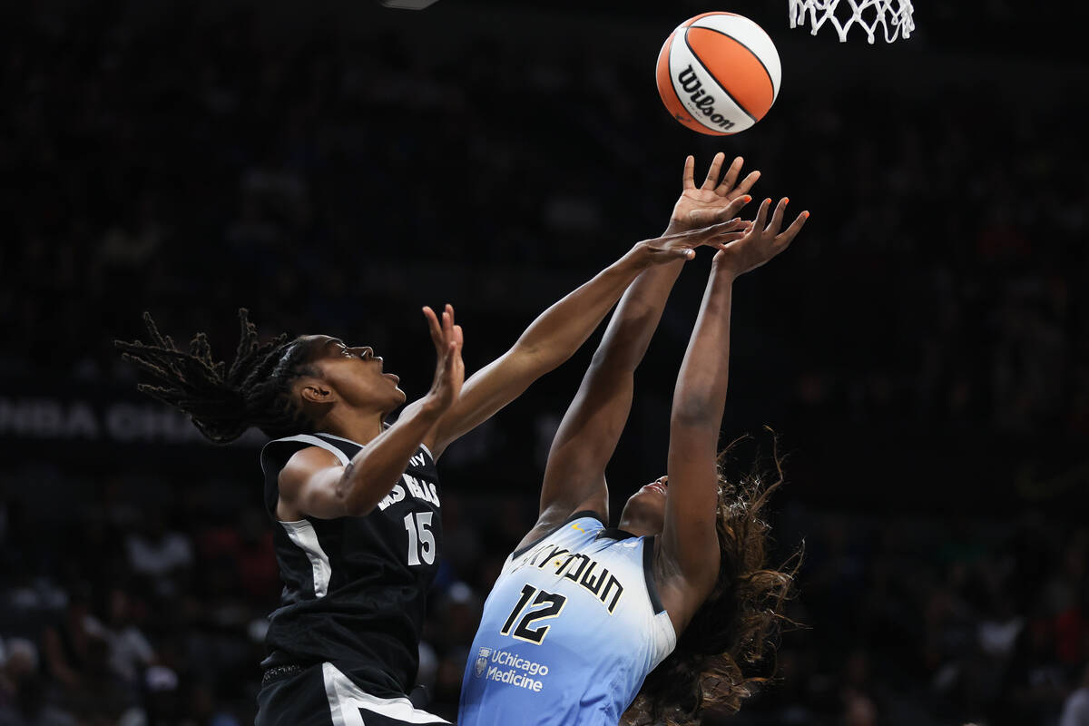 Las Vegas Aces guard Tiffany Hayes (15) fouls Chicago Sky forward Michaela Onyenwere (12) while ...