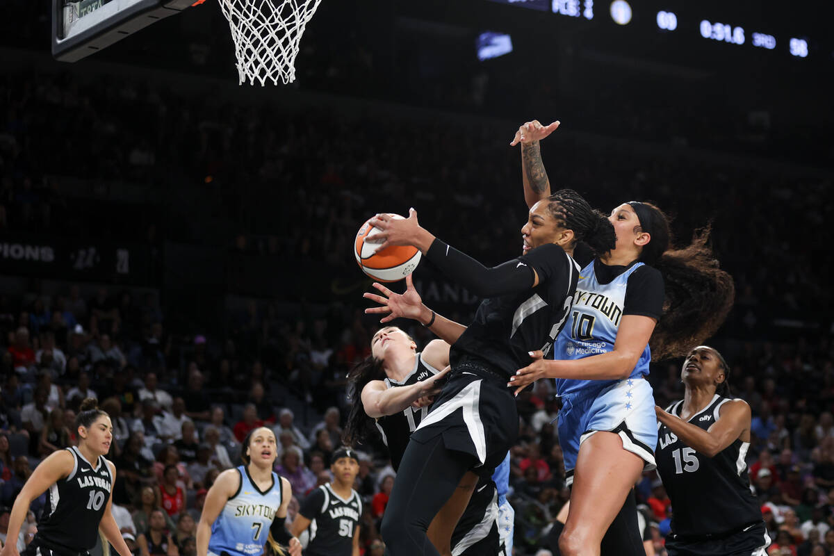 Las Vegas Aces center A'ja Wilson (22) snags a rebound over Chicago Sky center Kamilla Cardoso ...