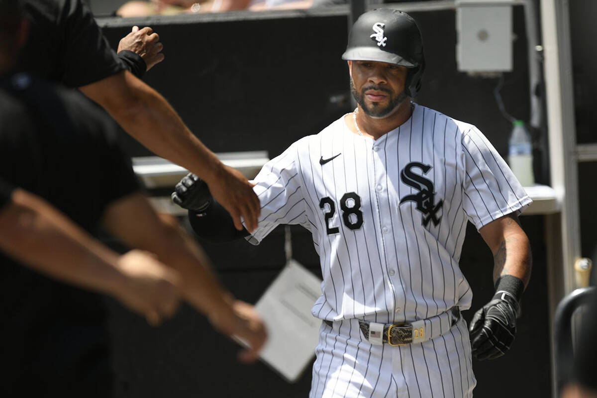 Chicago White Sox's Tommy Pham (28) celebrates with teammates in the dugout after scoring durin ...