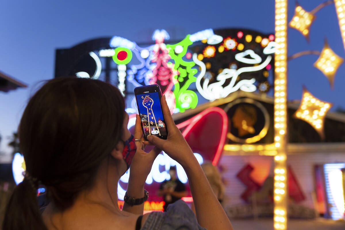 Kristine Bressel takes a photo during a tour at the Neon Museum on May 22, 2020, in Las Vegas. ...