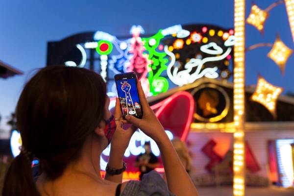 Kristine Bressel takes a photo during a tour at the Neon Museum on May 22, 2020, in Las Vegas. ...