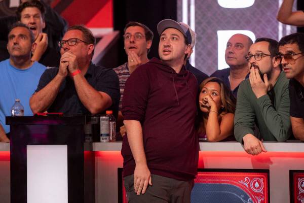 Jordan Griff, center, watches his hand play with family and friends in the final table of the W ...