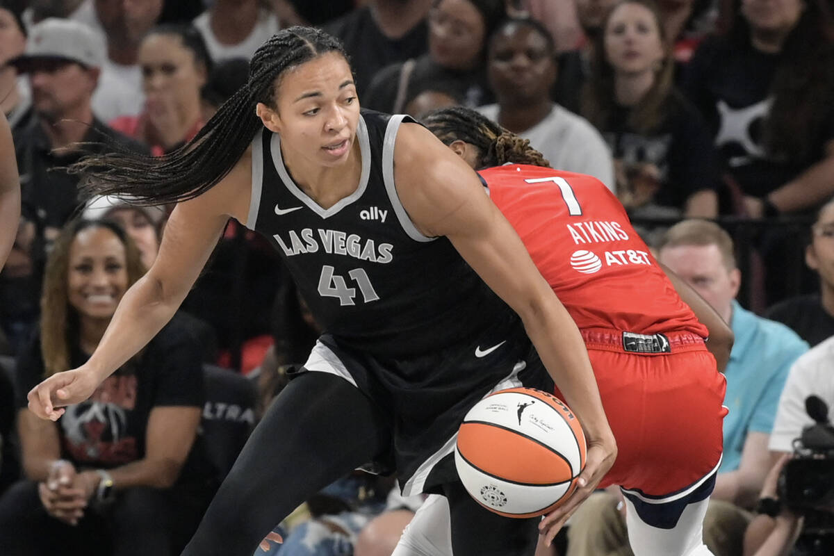 Las Vegas Aces center Kiah Stokes (41) drives around Washington Mystics guard Ariel Atkins (7) ...