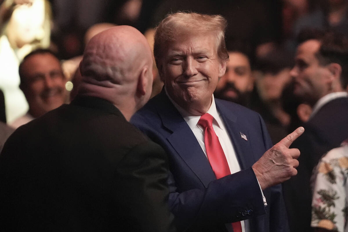 Former President Donald Trump, center right, talks to Dana White while attending the UFC 302 mi ...