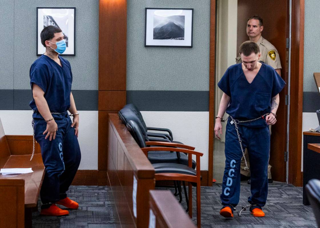 Jessie Rios, left, stands as his brother Adrian Rios enters the courtroom during their sentenci ...