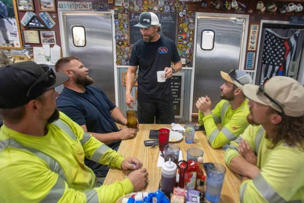 Co-owner Terry Stevens, center, talks with customers at The Coffee Cup Cafe, Friday, July 19, 2 ...