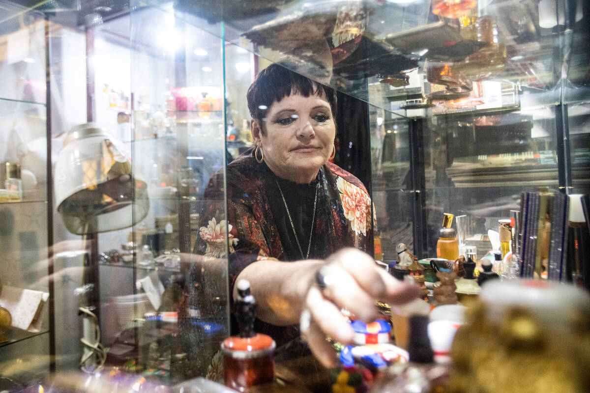 Co-owner Brenda Wright adjusts items on display at Sherman’s House of Antiques, Friday, ...