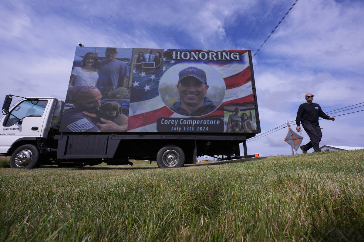 An electronic billboard displays a memorial for Corey Comperatore near the Butler Farm Show, Th ...
