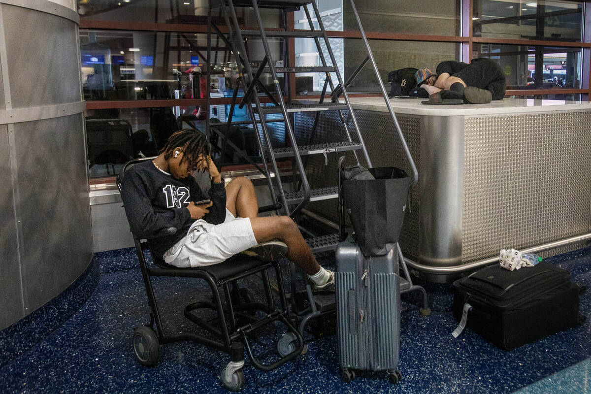 Passengers wait in the ticketing area at Harry Reid International Airport, Friday, July 19, 202 ...