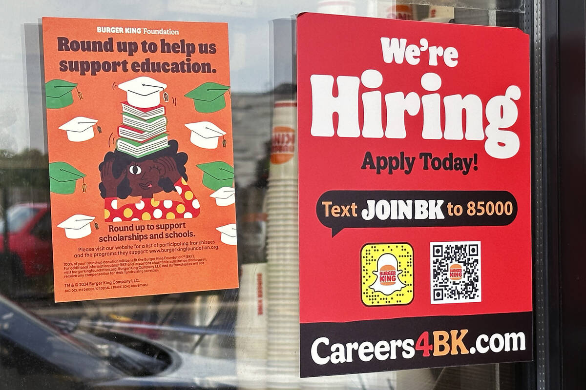 A hiring sign is displayed at a restaurant in Wheeling, Ill., May 16, 2024. (AP Photo/Nam Y. Hu ...