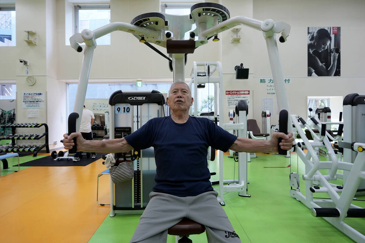 Shigeo Takahashi, 83, uses a pec deck machine as he works out at the Fukagawa Sports Center in ...