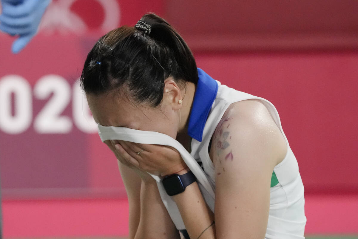 Beiwen Zhang, of the United States, cries after being injured and not being able to complete he ...