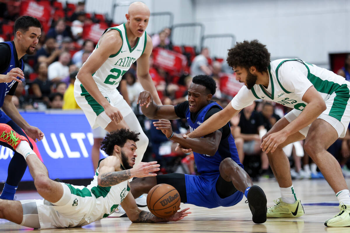 Dallas Mavericks forward Olivier-Maxence Prosper, center, vies for a loose ball against Boston ...