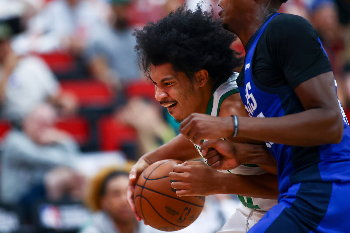 Boston Celtics forward Ron Harper Jr., left, drives toward the hoop against Dallas Mavericks fo ...