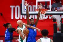 Boston Celtics forward Jordan Walsh shoots with pressure from Dallas Mavericks forward Alex Fud ...