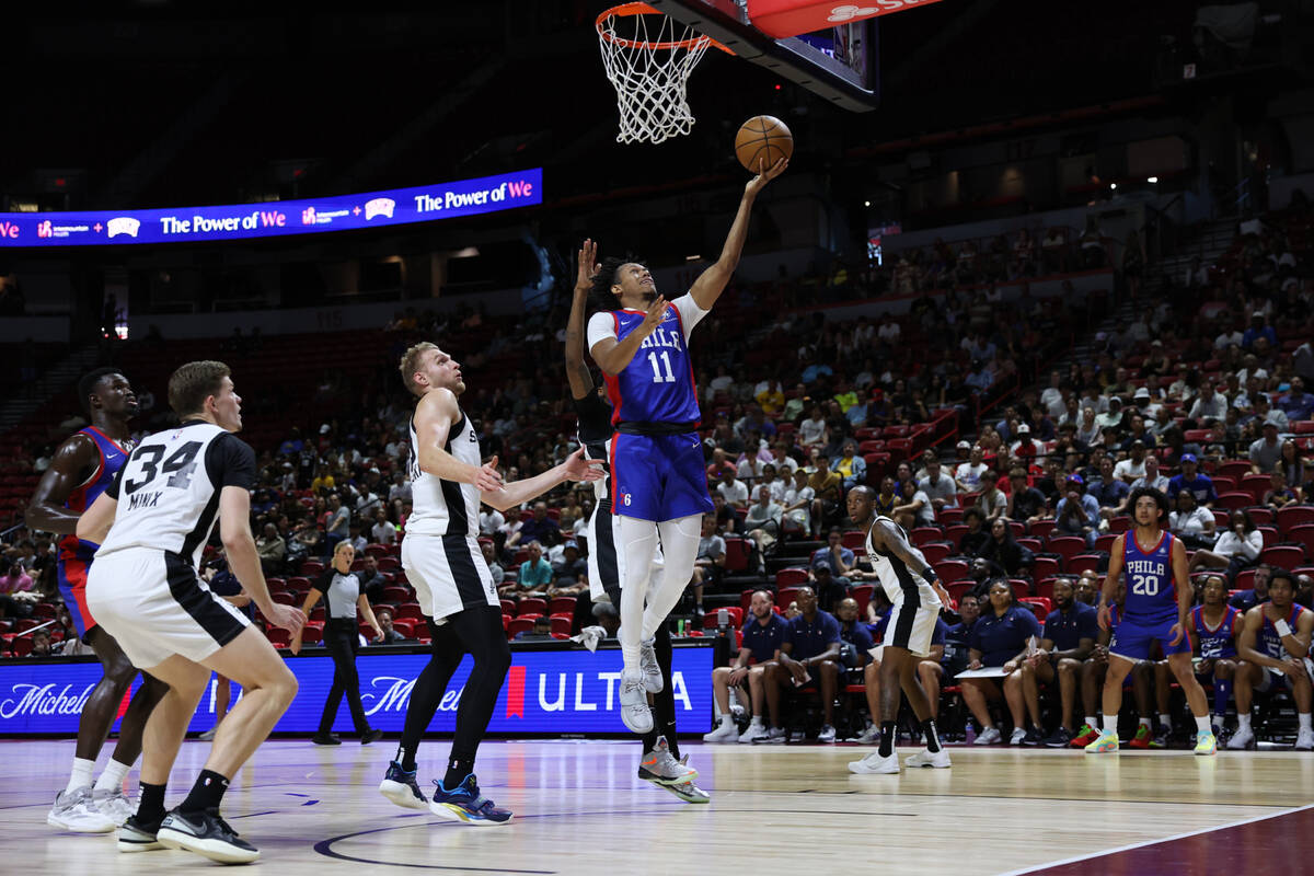 Philadelphia 76ers guard Jeff Dowtin (11) lays the ball in against the San Antonio Spurs during ...