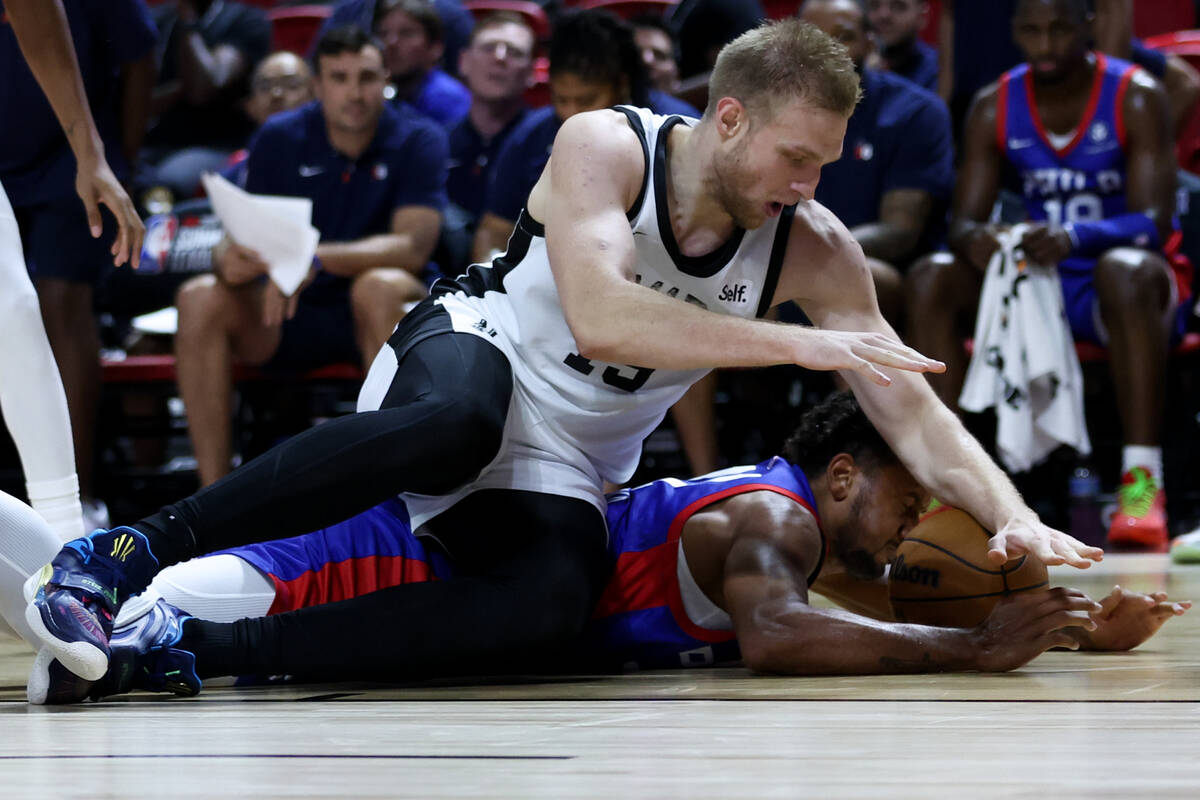 San Antonio Spurs forward Yauhen Massalski, above, and Philadelphia 76ers center Keve Aluma vie ...