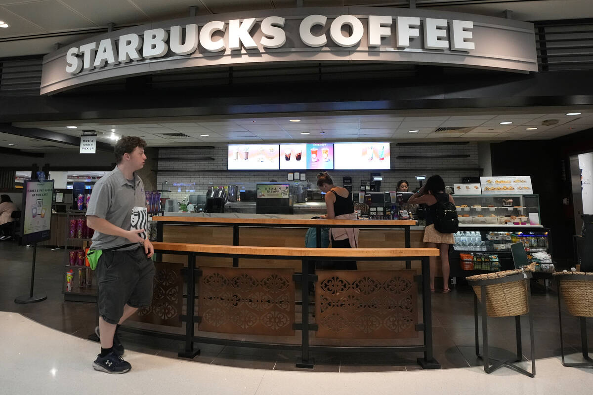 A patron walks out of a Starbucks at Phoenix Sky Harbor International Airport Friday, July 19, ...