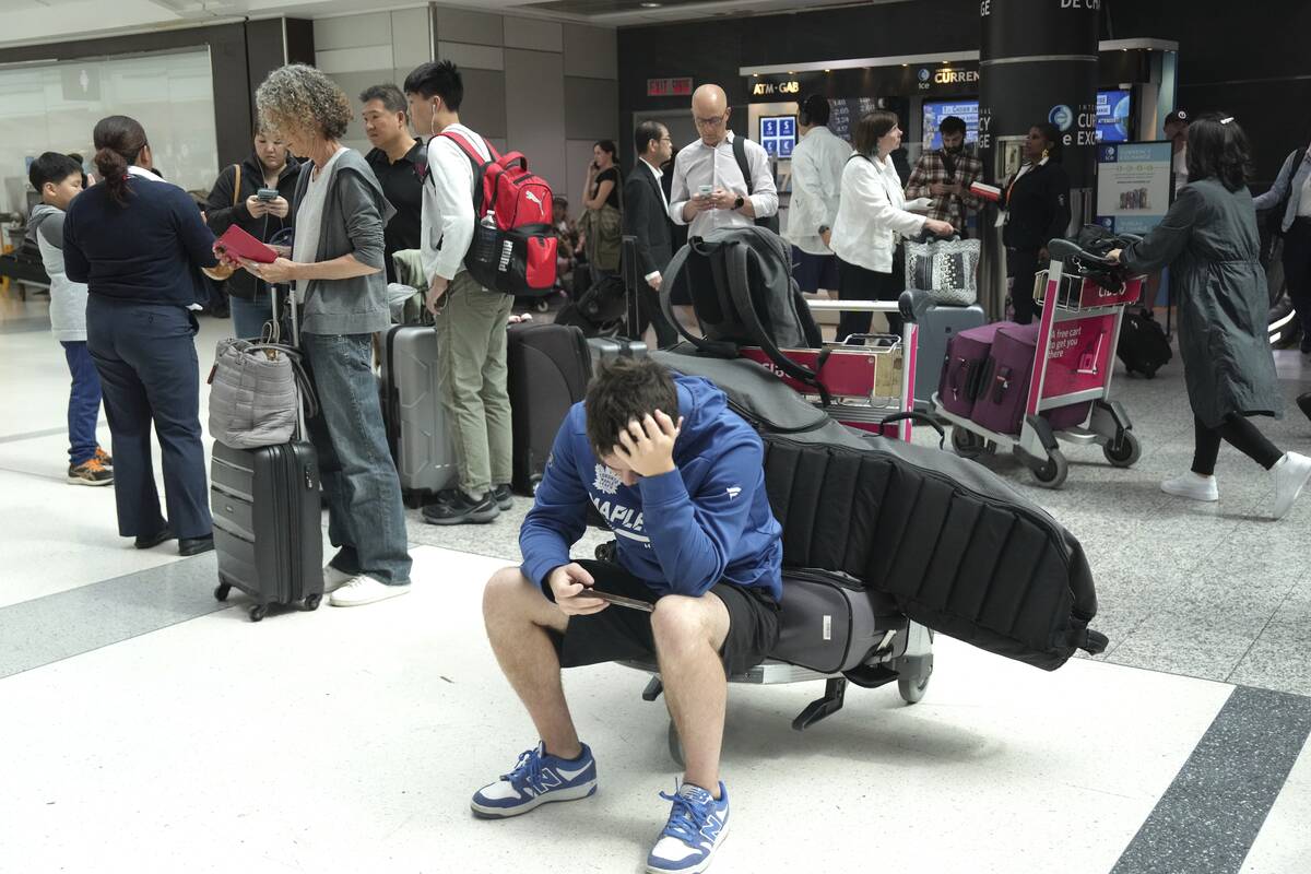 Porter Passengers wait at Toronto Pearson Airport on Friday, July 19, 2024, after a faulty Crow ...