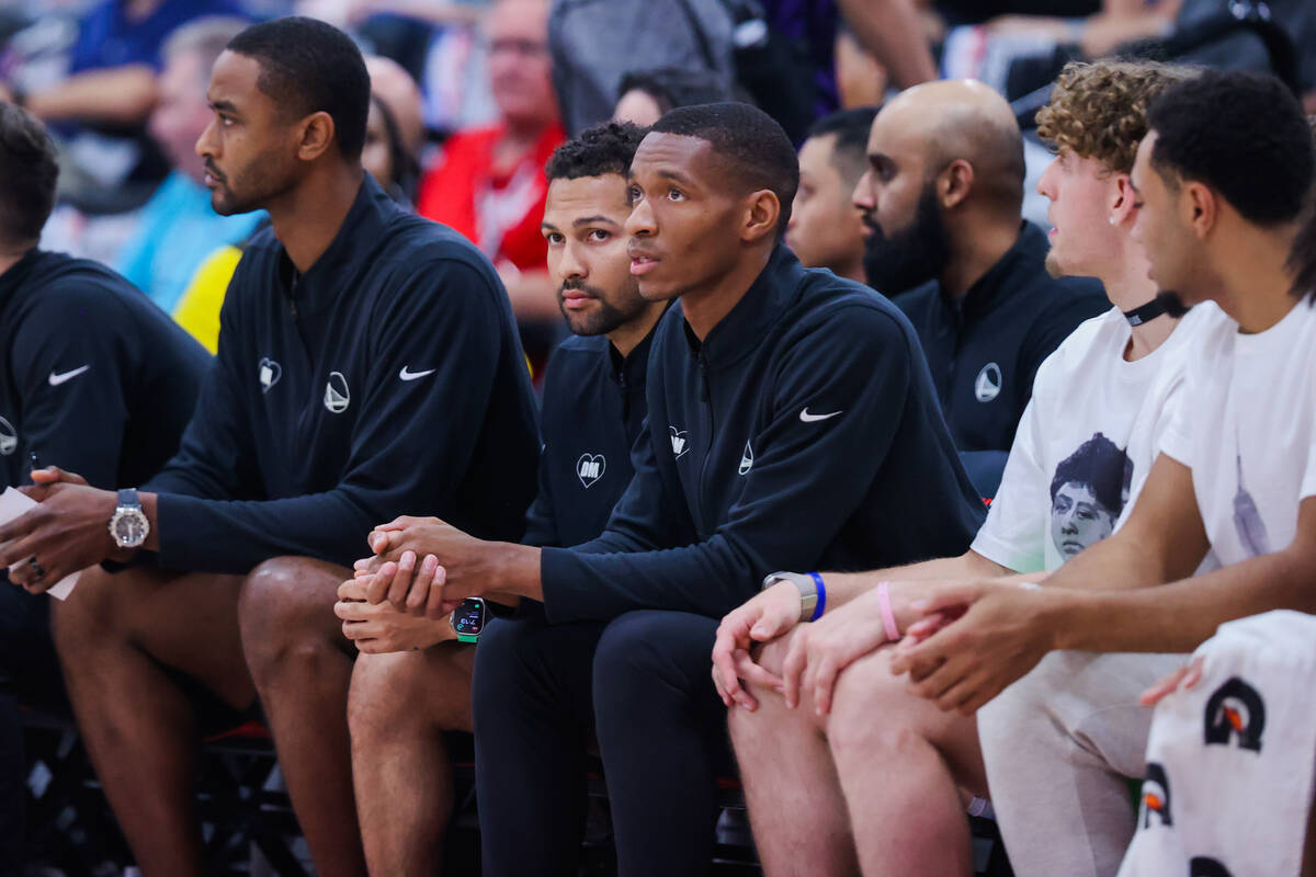 Golden State Warriors assistant coach Noah Robotham, second from left, watches game action from ...