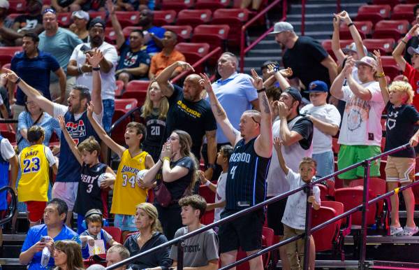 Fans wave for attention during the first half of an NBA Summer League game at the Thomas & Mack ...