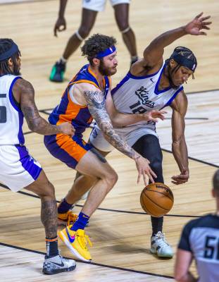 Phoenix Suns guard Logan Johnson (16) collides with Sacramento Kings forward Xavier Sneed (18) ...