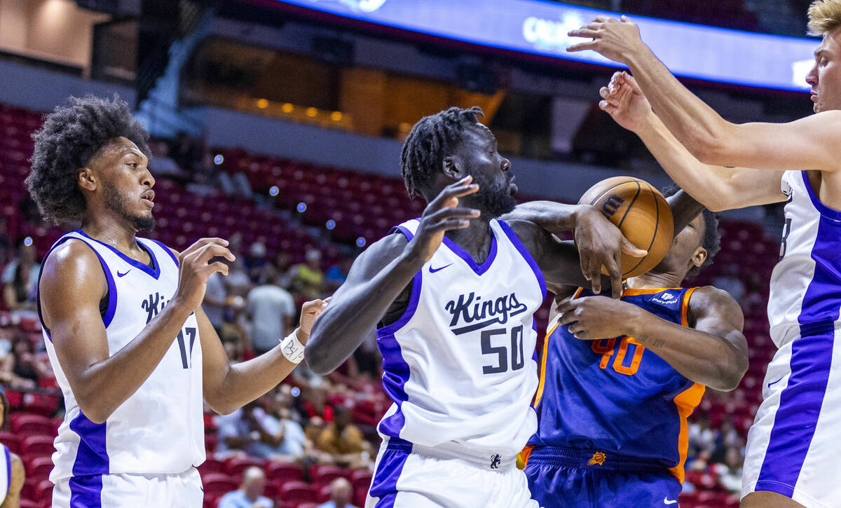 Sacramento Kings center Jo Lual-Acuil Jr. (50) fights for a loose ball with Phoenix Suns forwar ...