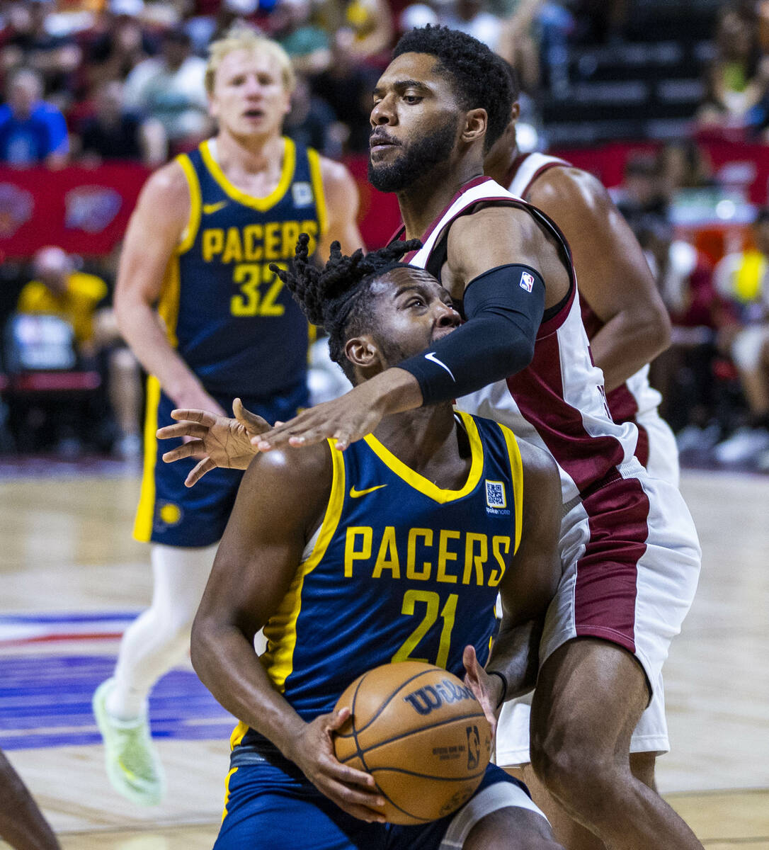 Indiana Pacers guard Lance Jones (21) runs into the arm of Cleveland Cavaliers guard Jayvon Gra ...