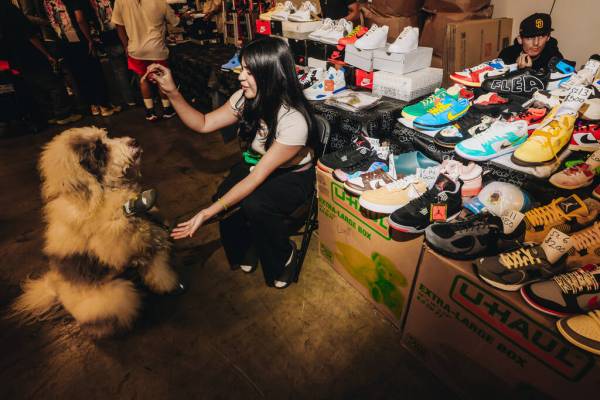 Ashley Martin Del Campo feeds her dog, Kobi, a treat during Sneaker Con at the Mandalay Bay Con ...