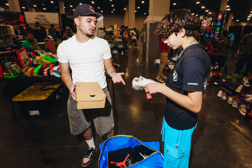 Attendees look into trading a pair of sneakers during Sneaker Con at the Mandalay Bay Conventio ...