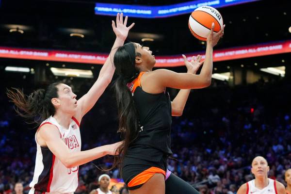 CORRECTS TO REESE NOT REECE - Angel Reese, front right, of Team WNBA, drives past Breanna Stewa ...