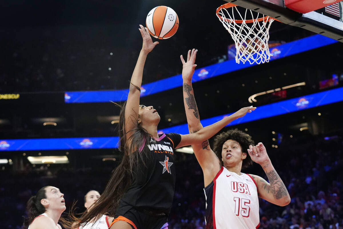 CORRECTS TO REESE NOT REECE - Angel Reese, second from right, of Team WNBA, shoots over Brittne ...