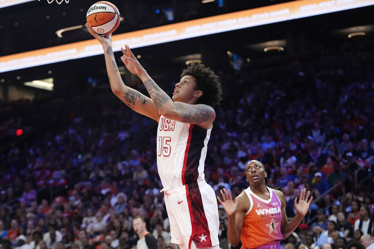 Brittney Griner, left, of Team USA, gets past Nneka Ogwumike, right, of Team WNBA, to score dur ...