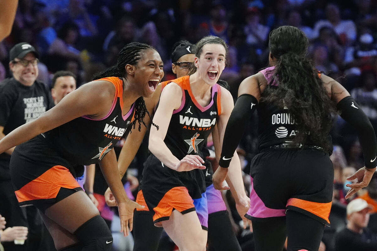 Arike Ogunbowale, right, of Team WNBA, celebrates after her 3-point basket against Team USA wit ...