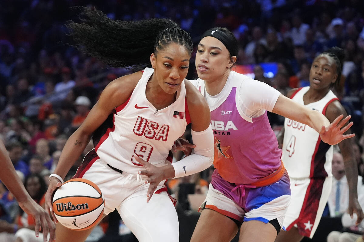 A'ja Wilson (9), of Team USA, drives past Dearica Hamby, front right, of Team WNBA, during the ...