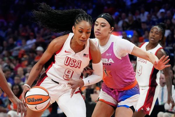 A'ja Wilson (9), of Team USA, drives past Dearica Hamby, front right, of Team WNBA, during the ...