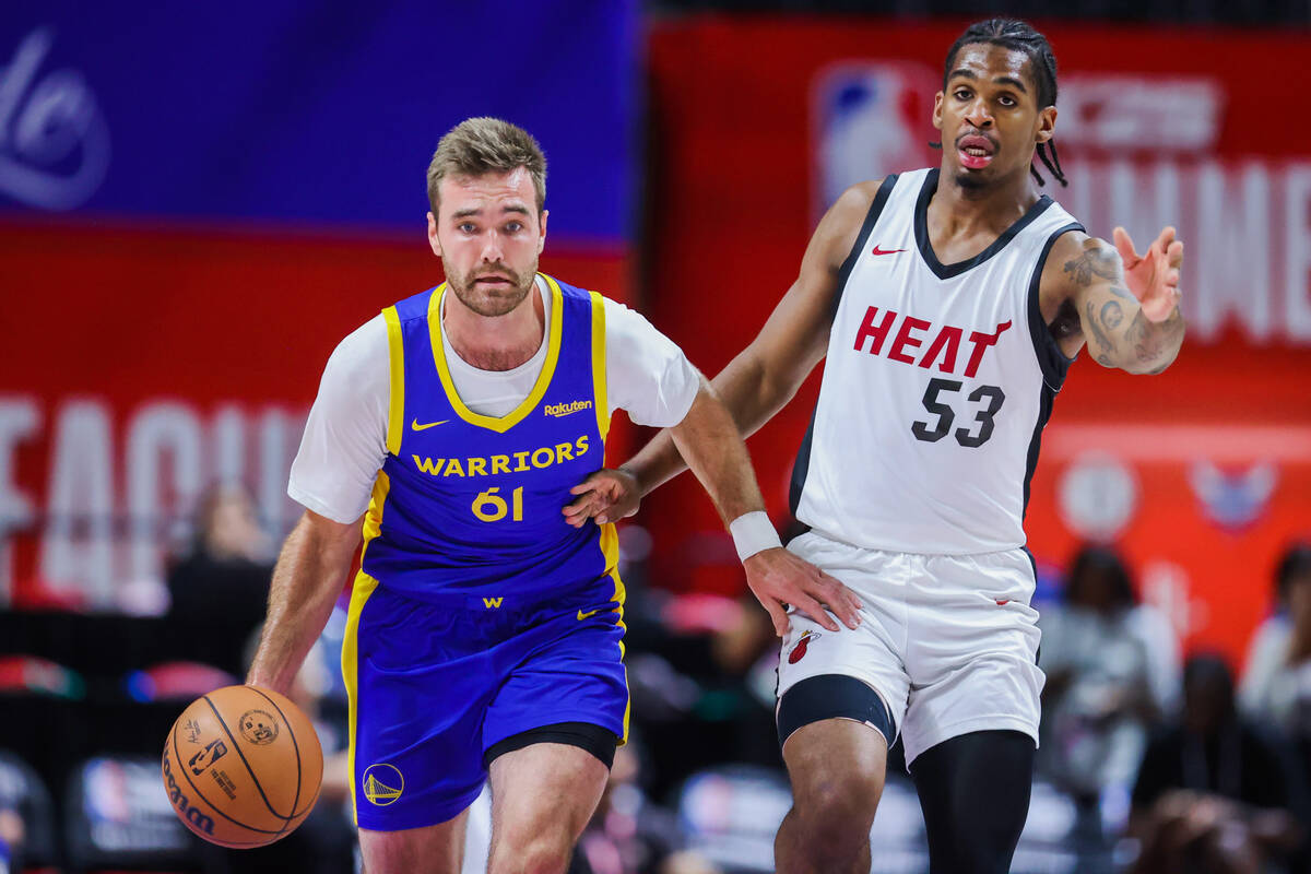 Golden State Warriors guard Pat Spencer (61) dribbles the ball as Miami Heat guard Josh Christo ...