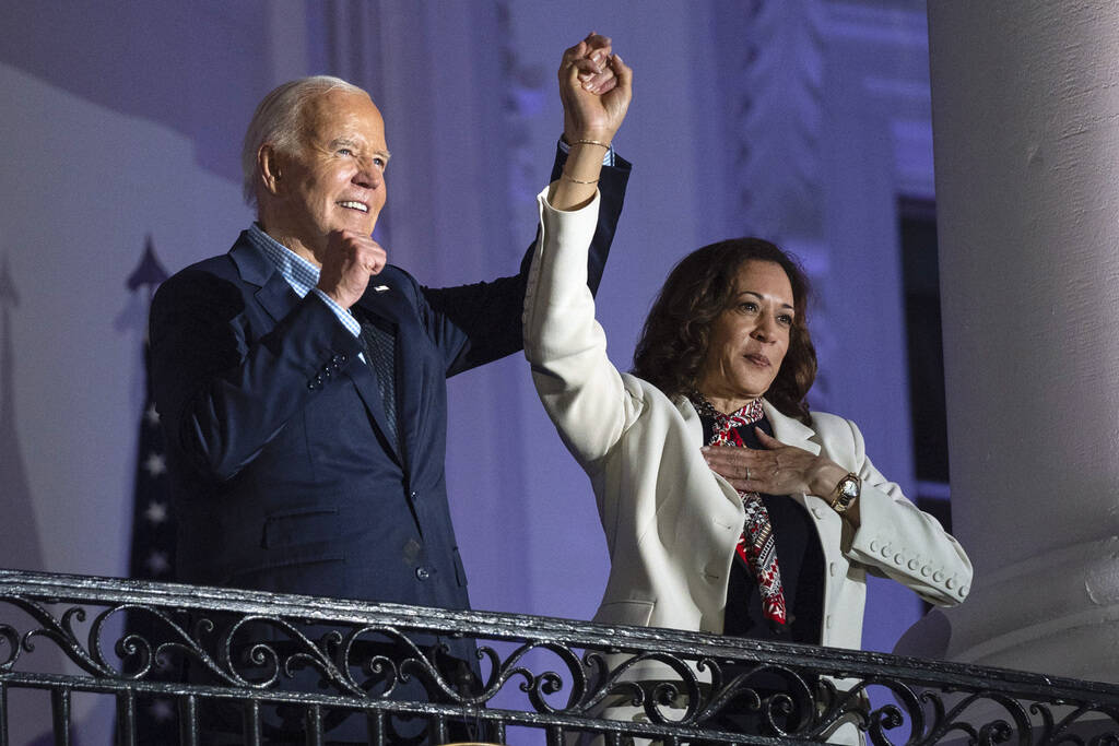 President Joe Biden raises the hand of Vice President Kamala Harris after viewing the Independe ...