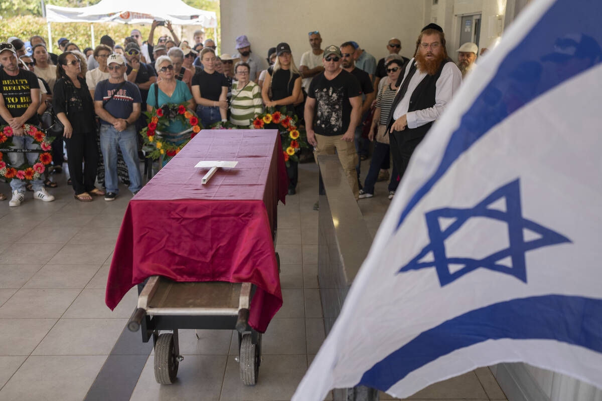 Family and friends of Yevgeny Ferde attend his funeral at a cemetery in Rishon Lezion, Israel, ...