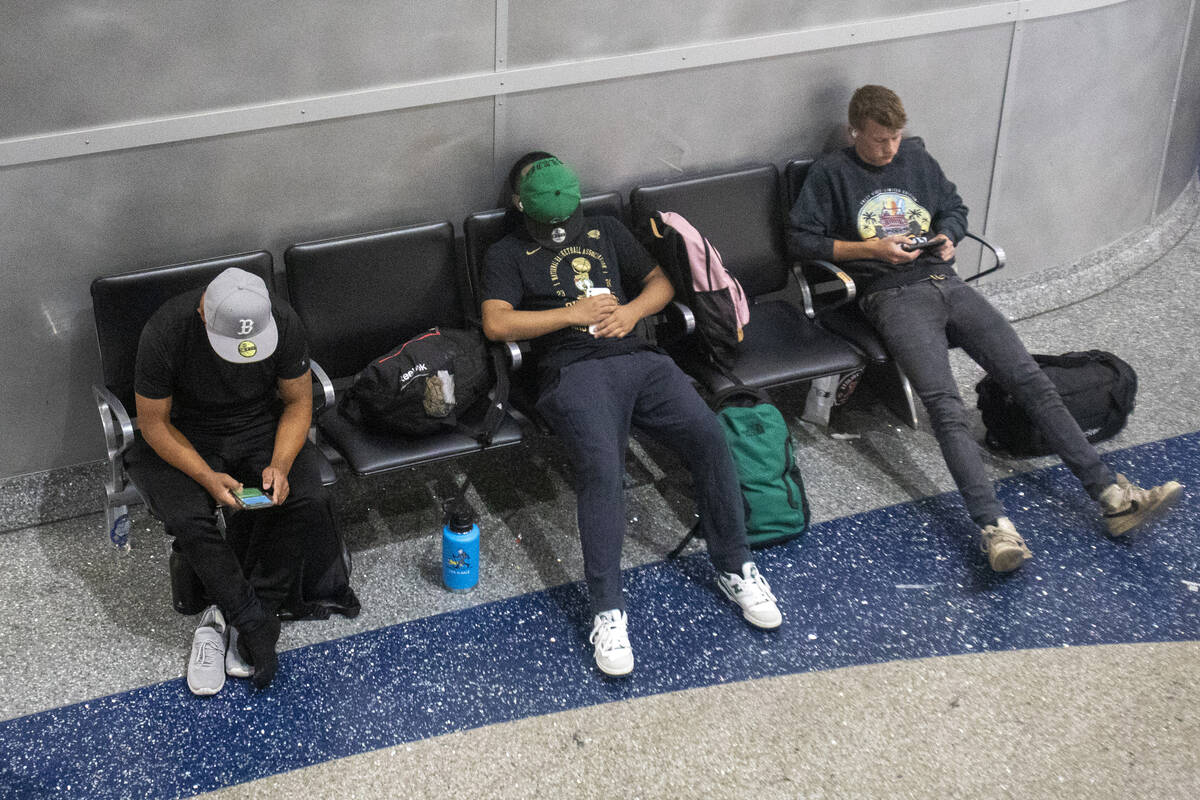 Passengers wait in the ticketing area at Harry Reid International Airport, Friday, July 19, 202 ...