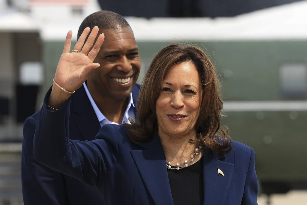 Vice President Kamala Harris waves before boarding Air Force Two as she departs on campaign tra ...