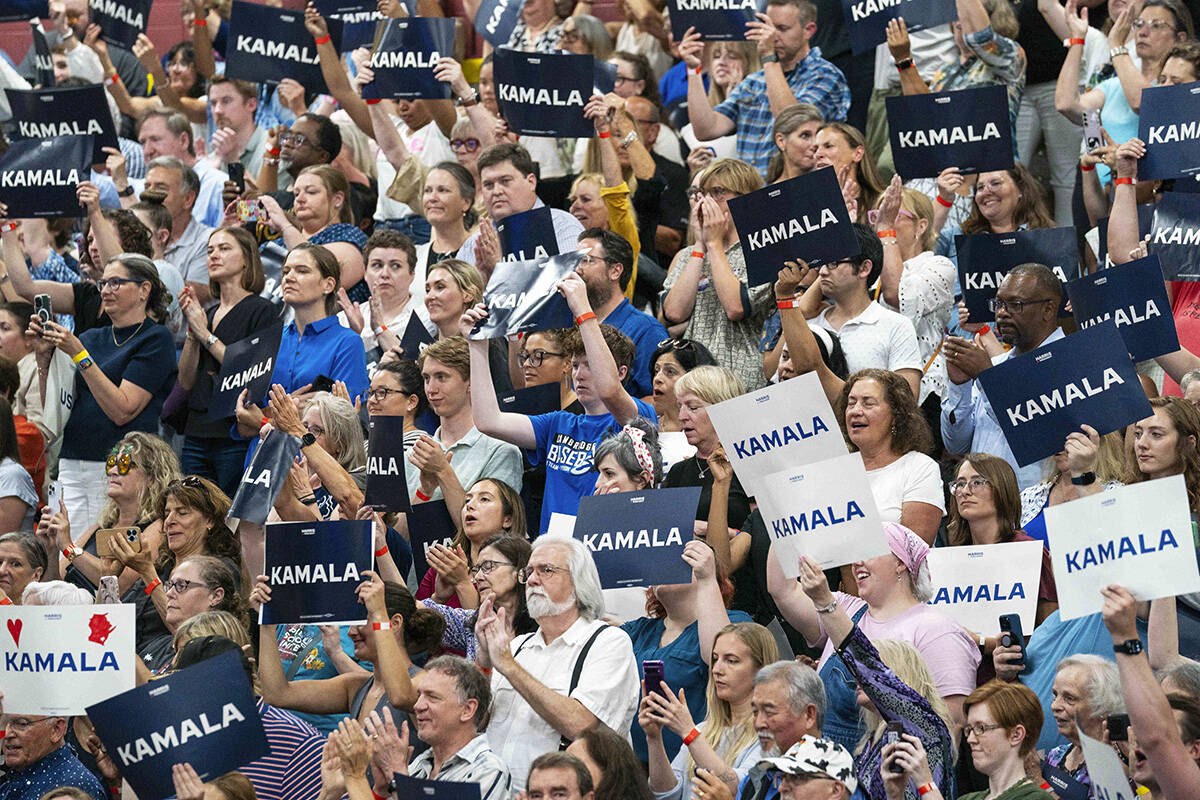 Supports hold up signs in support of Vice President Kamala Harris as she campaigns for Presiden ...