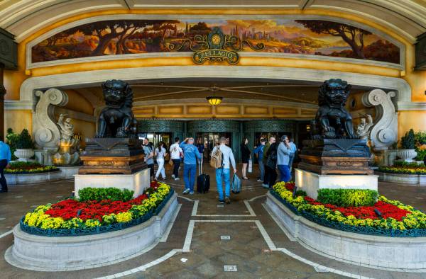 Visitors walk about the entrance to the Bellagio on Friday, March 1, 2024, in Las Vegas. (L.E. ...