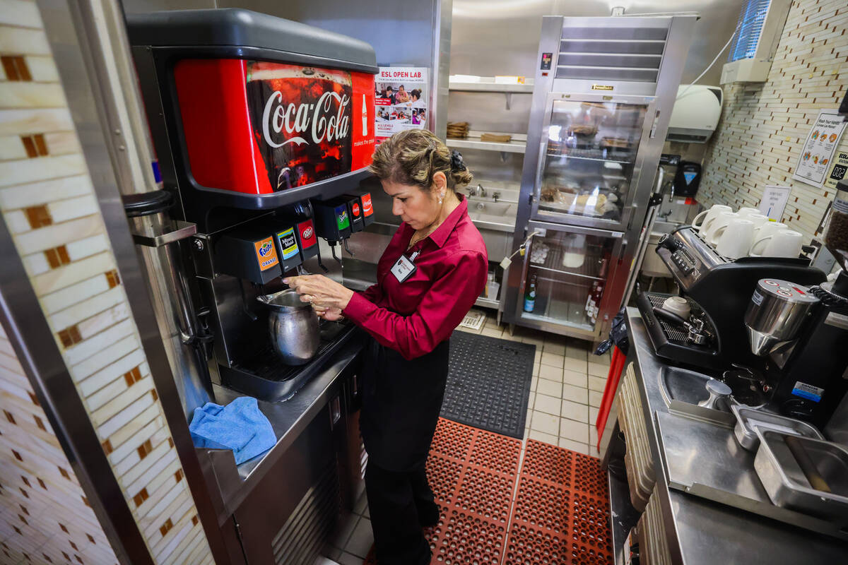 A student server fills up a pitcher inside of the Westside Bistro at the Culinary Academy of La ...