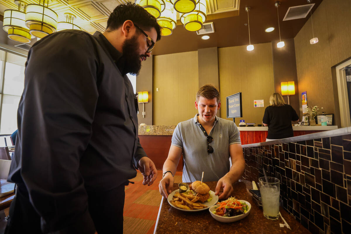 Pablo Partida, a student server, serves Jakob Bernhardt his lunch inside of the Westside Bistro ...