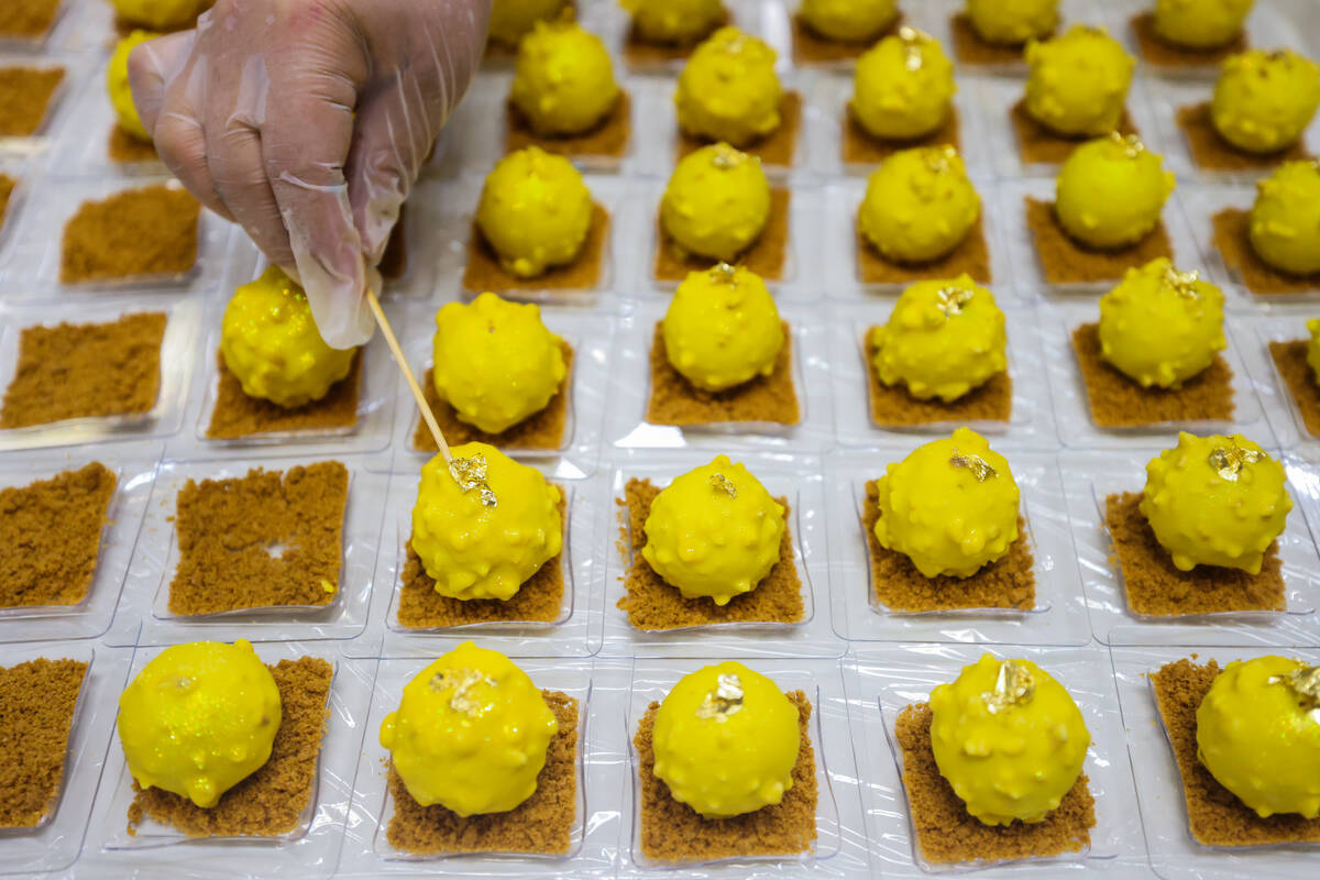 A student puts fine touches on decorated sweets at the Culinary Academy of Las Vegas on Friday, ...