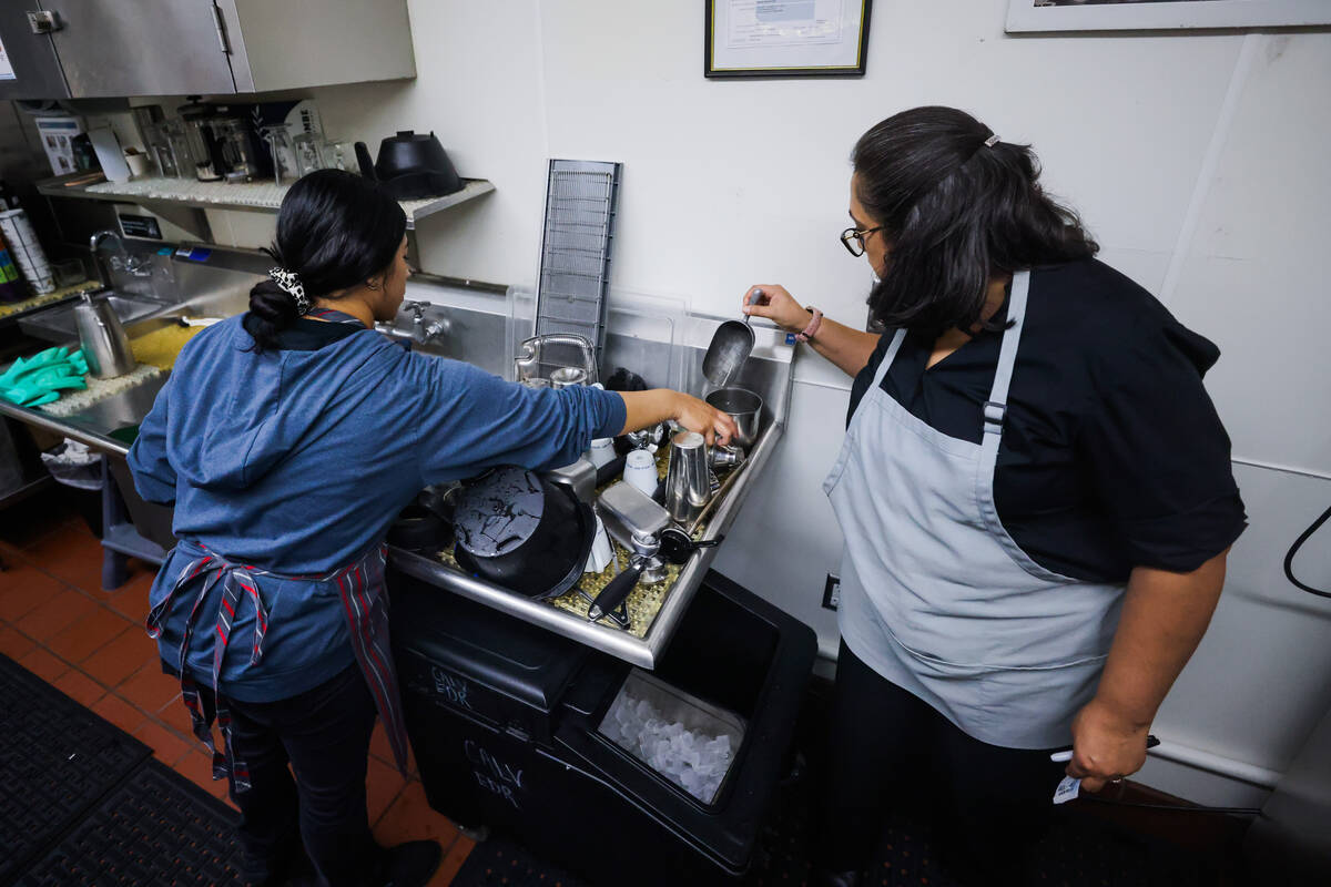 Student baristas clean dishes inside of a student coffee shop at the Culinary Academy of Las Ve ...