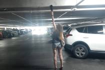 A woman shows how shoeprints get on the ceilings and cross beams of Las Vegas casino parking ga ...